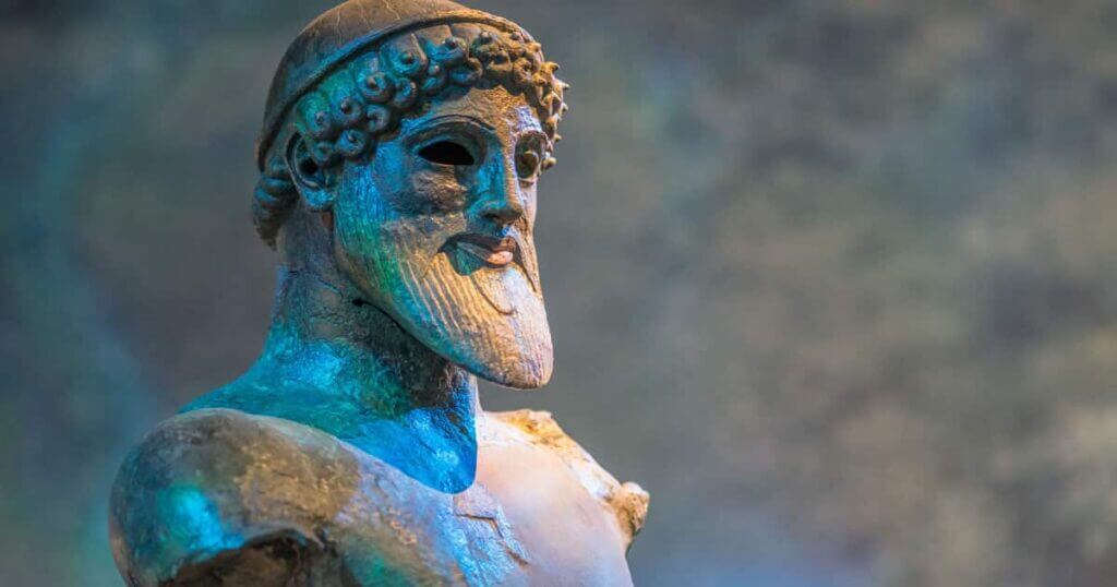 A mythological statue depicting a bearded man.
